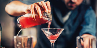 barman pouring cocktail