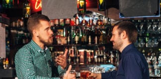 Men in bar drinking whisky