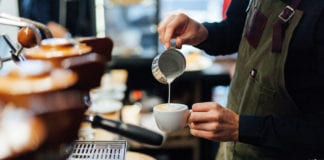 Barista pouring coffee