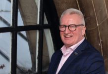 Gordon McIntyre is sitting by a window.