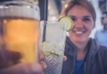 woman smiling holding cocktail