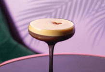 An espresso martini on a purple backdrop