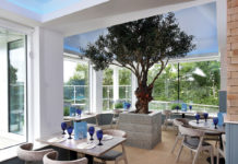 a restaurant interior with blue and white interior and a tree in the middle of the room