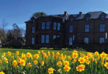 Exterior of the Douglas Hotel on Arran with daffodils in the foreground