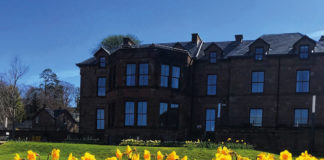 Exterior of the Douglas Hotel on Arran with daffodils in the foreground