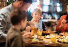 A family with young children eat in a pub restuarant