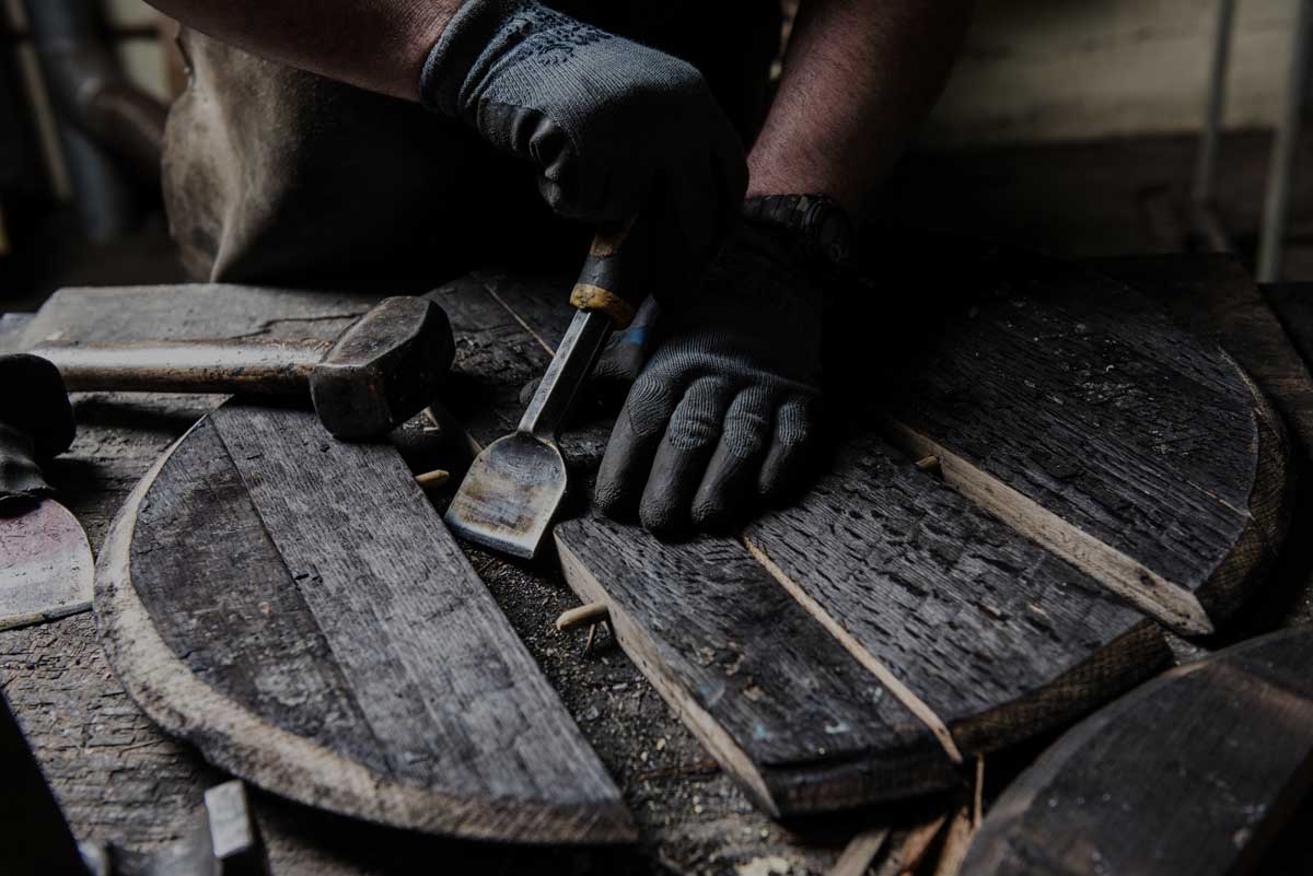 A cooper works on a whisky barrel at Balvenie Distillery