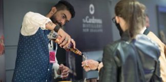 a bartender pours whisky samples