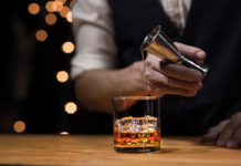 man pouring whisky