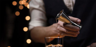 man pouring whisky