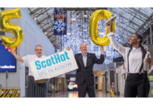 ScotHot staff with sign and '50' balloons
