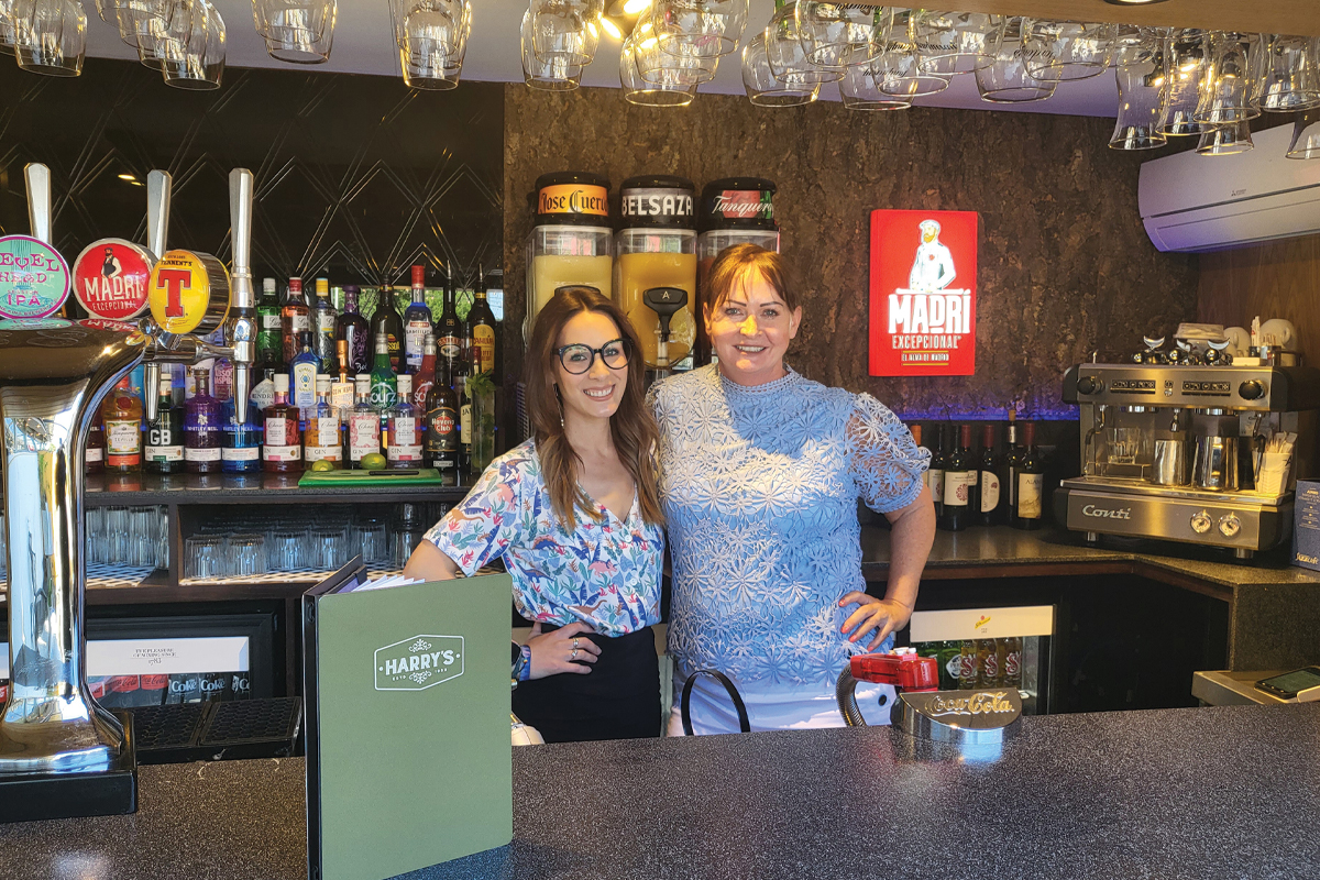Lisini, Angels Hotel's Siobhan and Kay standing behind bar