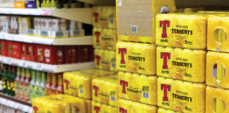 Crates of Tennents stacked in a supermarket