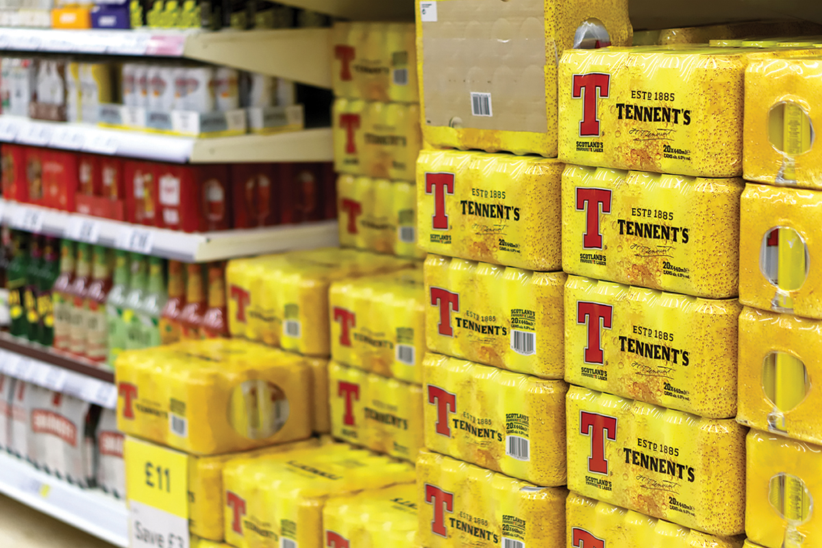 Crates of Tennents stacked in a supermarket