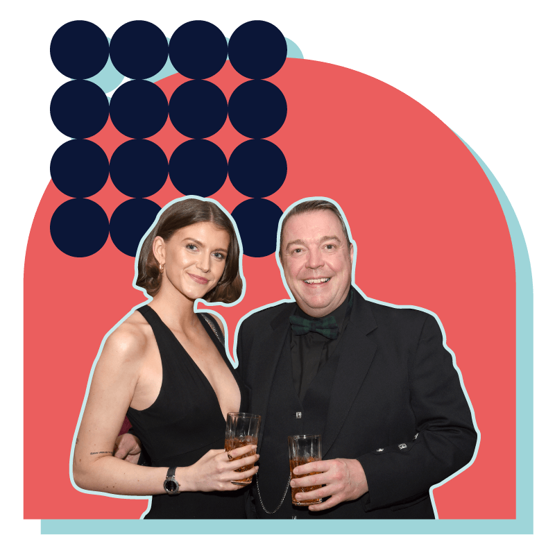 a man and woman holding cocktails