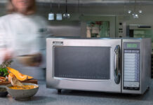 a silver sharp microwave in an industrial kitchen