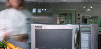 a silver sharp microwave in an industrial kitchen