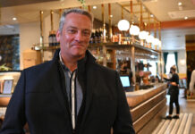 a man stands in front of a art deco style bar