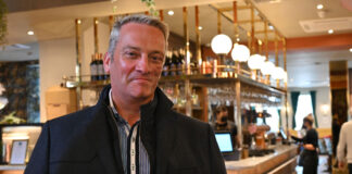a man stands in front of a art deco style bar