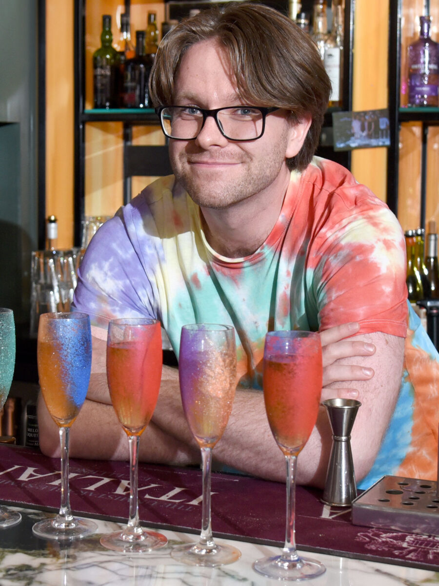 A bartender with some freshly poured cocktails