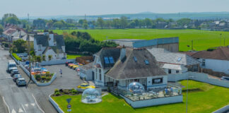 A converted golf club house surrounded by green lawns