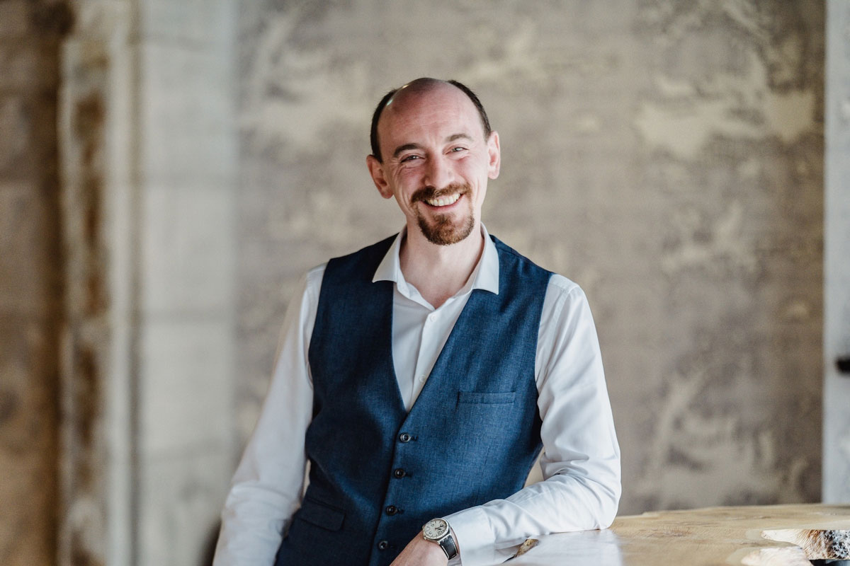 A smiling man in a waistcoat