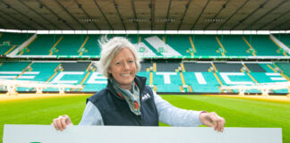 A woman smiles in a football stadium