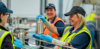 Workers on a production line wearing high-visibility tabards