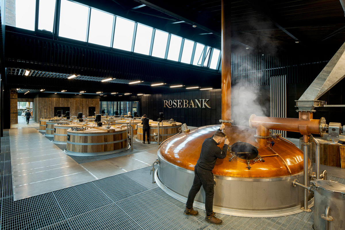 A man working inside a whisky distillery