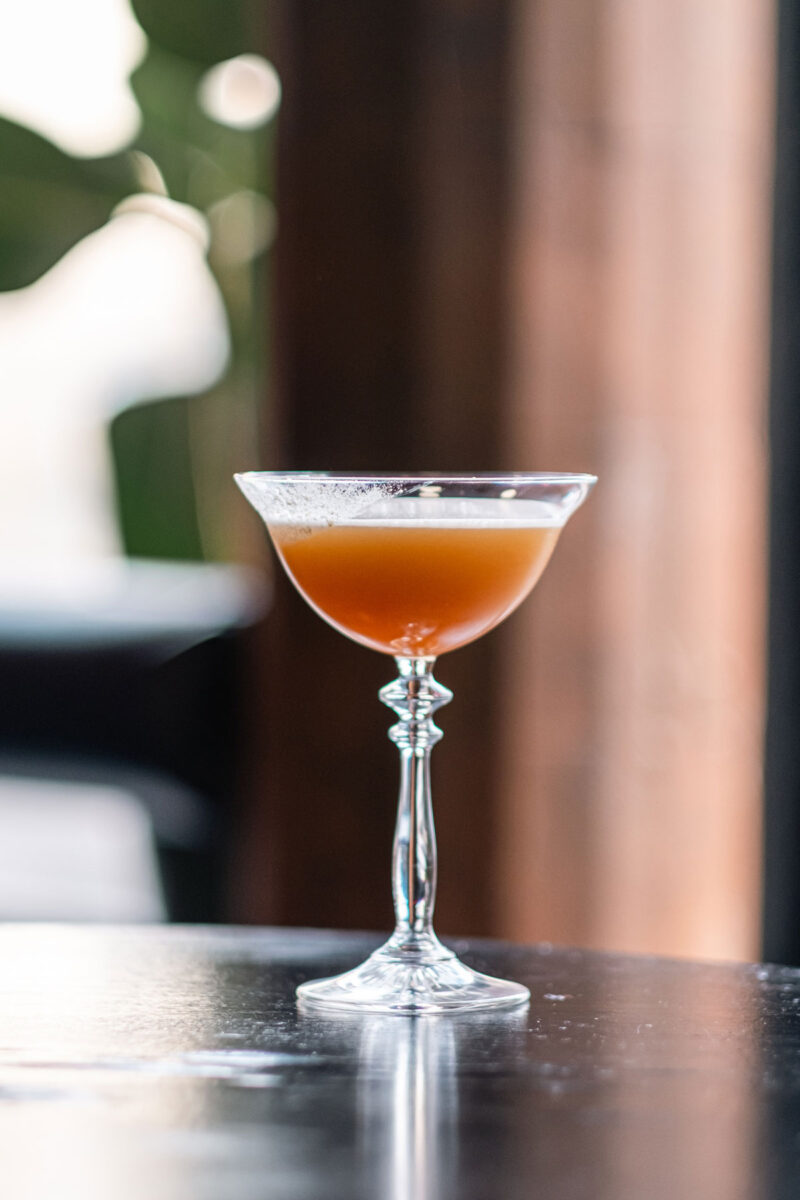 A beer-coloured cocktail in an an old fashioned glass