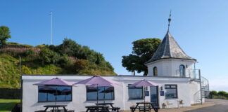 A seaside cafe with a pink roof