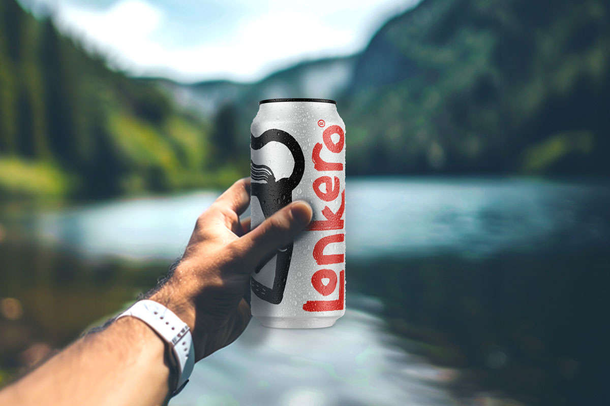 A man's hand holds up a drink can against a nordic background