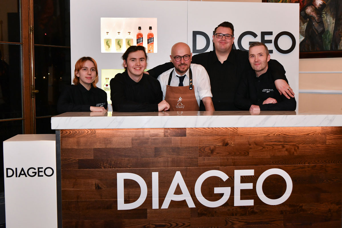Barstaff trainees behind a bar with a mentor
