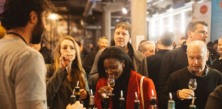 Two ladies sample whisky at a trade stand