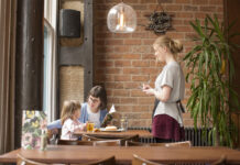 waitress serving mother and daughter in a casual restaurant
