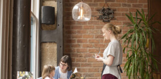 waitress serving mother and daughter in a casual restaurant