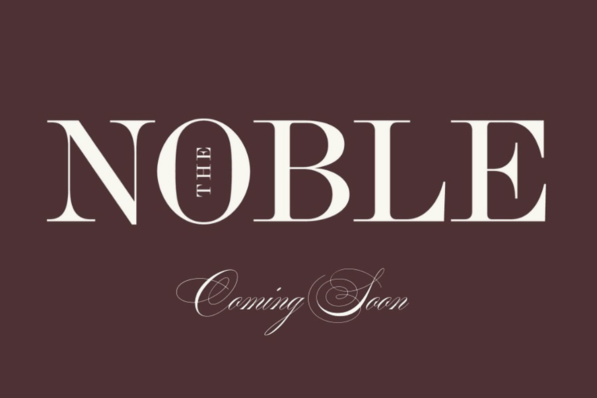 a white logo on a brown background for 'The Noble'