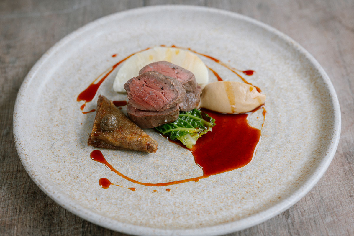 A plate of fine food, with bright red sauce