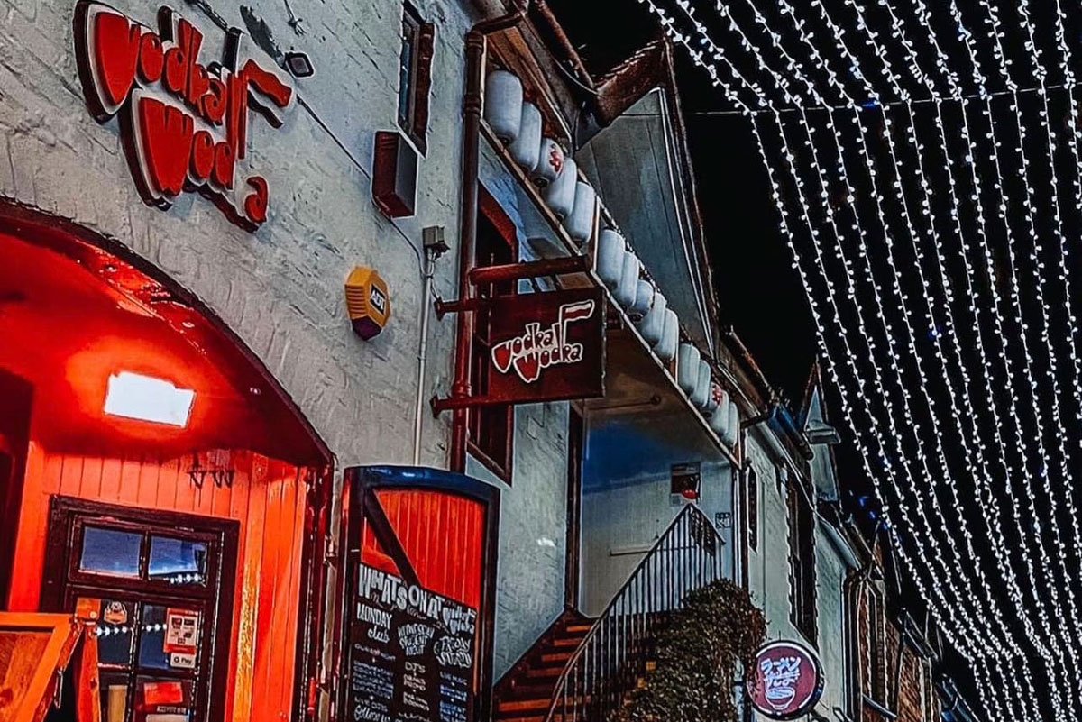 a brightly coloured bar upstairs in a mews building