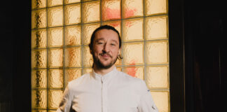 A young bearded man in chef's whites