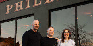 Three hospitality professionals outside a restaurant