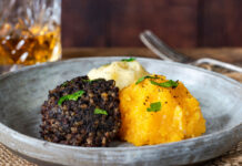 A plate with haggis, keeps and tatties.