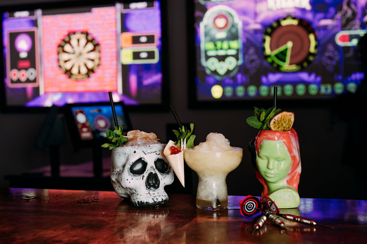 Three unusually shaped cups containing exotic iced drinks