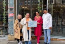 Dunfermline’s Dhoom continues its commitment to community charities A charity cheque presentation outside a restaurant