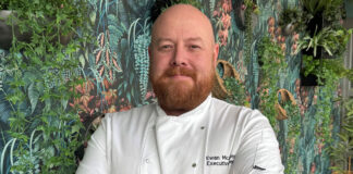 a smiling bearded man in chef's whites