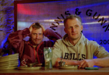 A comedian feigns exasperation next to a man who has just eaten quite a lot