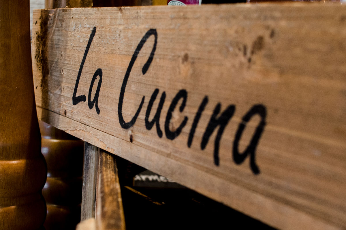 an Italian restaurant sign that translates as 'The Kitchen'