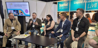A panel of pub professionals sit on stools and pass round a microphone