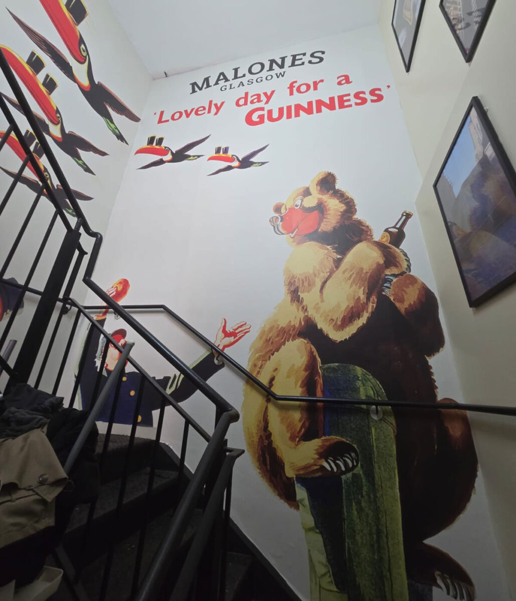 An advertising mural in a stair well