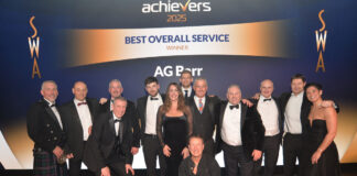 Smartly dressed Scottish people line up on stage after receiving an award